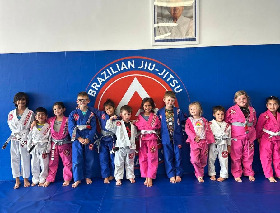 Little Champions students lined up in their gis in front of the Gracie Barra wall, Fleming Island FL