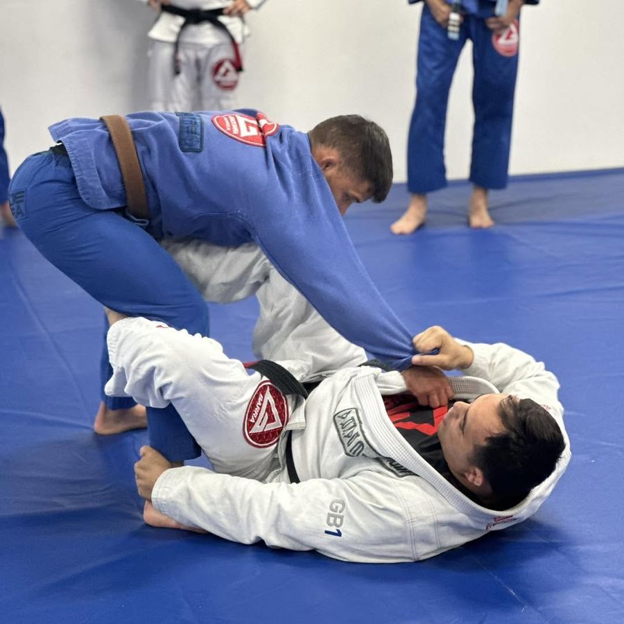 Two adult students in blue gis training takedowns in a GB1 class, Fleming Island FL