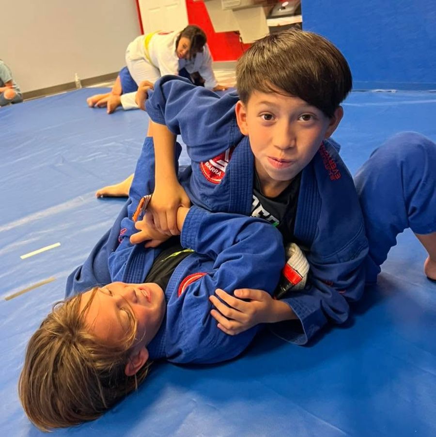 Instructor training on the mat with a young student in a Little Champions 2 class, Fleming Island FL