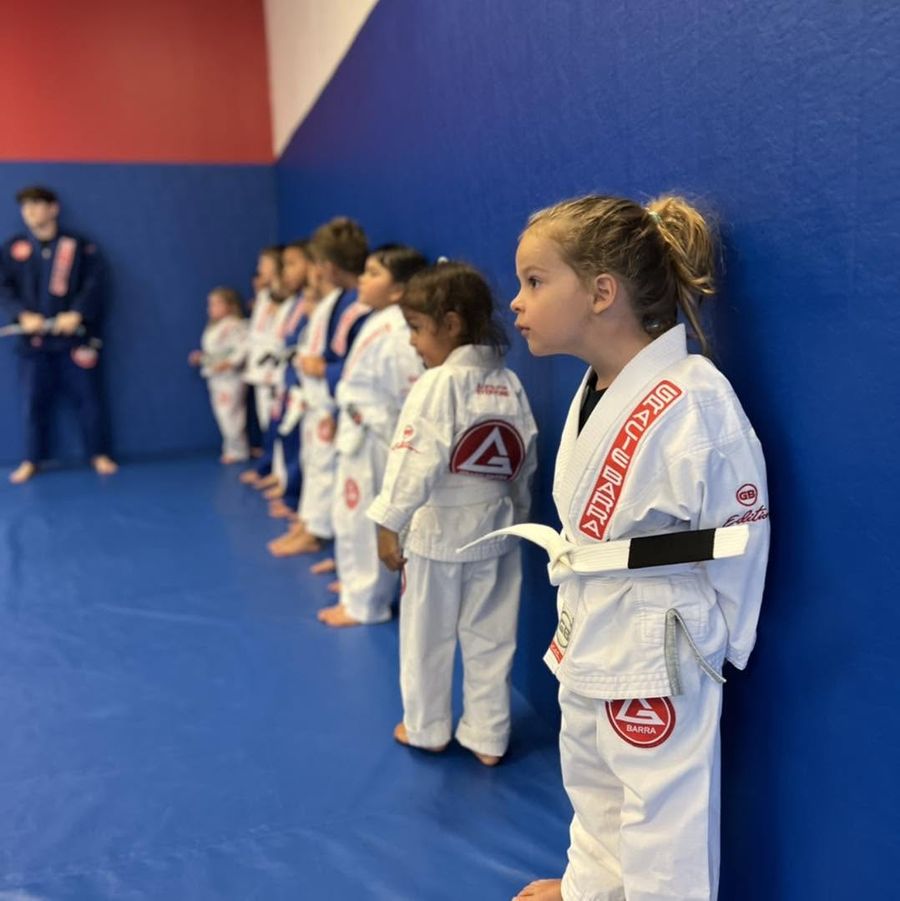 Young children in white and blue gis grappling during a Tiny Champions class, Fleming Island FL